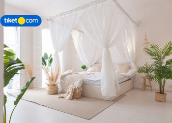 bed with curtains white at hotel