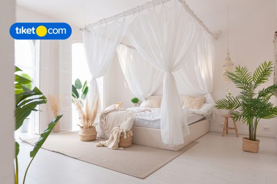 bed with curtains white at hotel