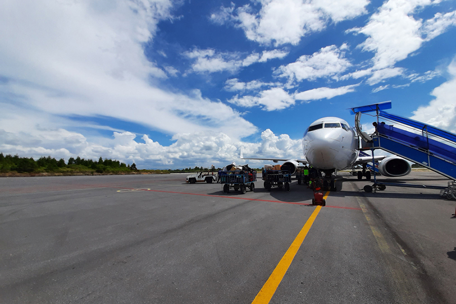 Silangit DTB Airport, North Sumatra Indonesia, 9 January 2020 : People walk to plane before plane take off to Jakarta,the weather is very sunny